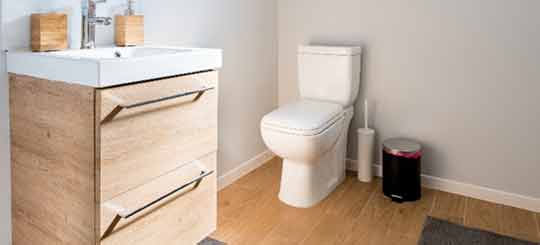 A white ceramic toilet in a bathroom.