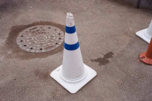 A utility hole cover marked off so a professional can do a check to know if a sewer line is broken.