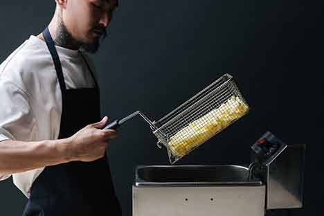 a chef holding a fryer