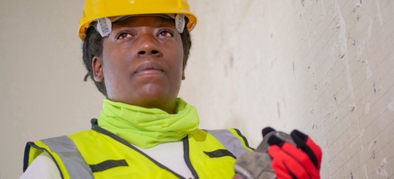 A plumber holding a plumber’s wrench.