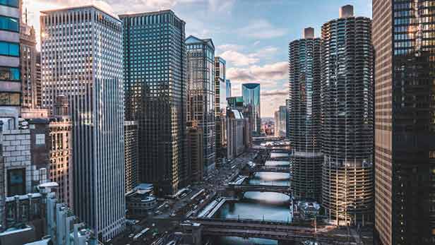 Tall buildings and three bridges that connect the two banks of the Chicago river.