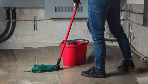a man cleaning up after basement flooding