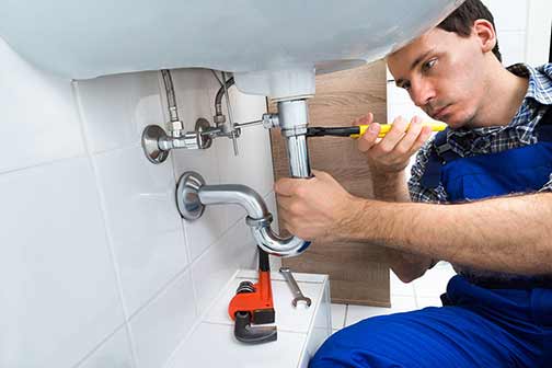 a plumber installing a new bathroom plumbing fixture