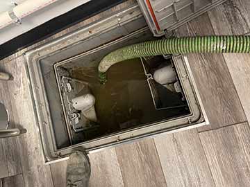 a restaurant grease trap being cleaned out in chicago.