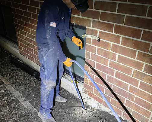 a plumber in the middle of a commercial hydro jetting service in chicago.