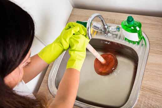 a lady performing diy drain cleaning.
