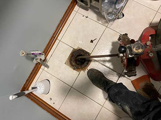 a plumber clearing a drain with drain rooter service in chicago.
