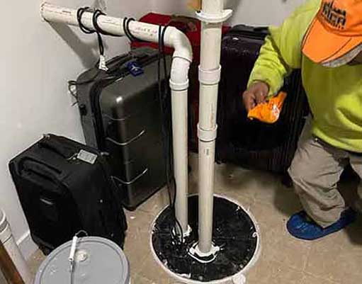 a plumber performing an ejector pump replacement in chicago.