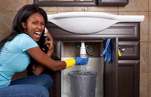 a woman in need of emergency plumbing repairs.