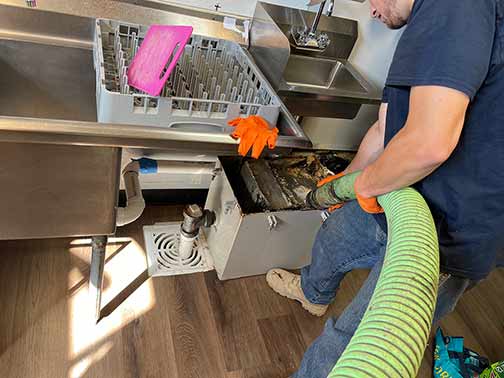 a grease trap pumping taking place in a chicago restaurant.