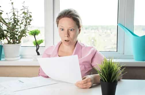 a woman reading her high water bill