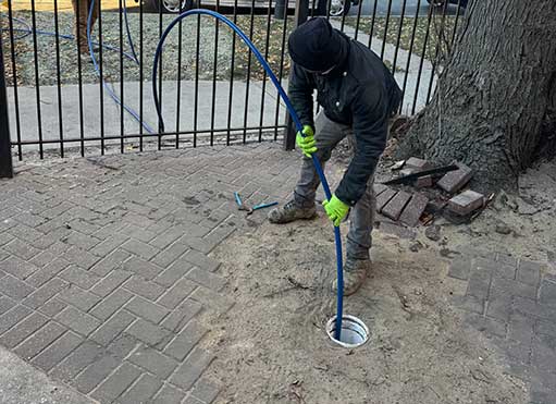 a plumber performing a professional drain cleaning.
