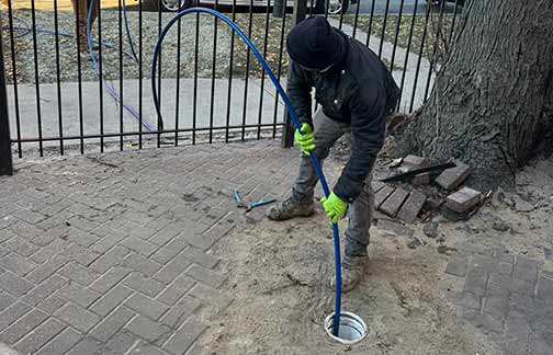 a professional plumber performing a hydro-jetting.