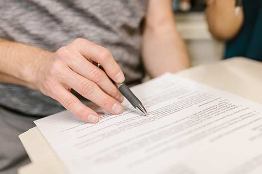 a lease agreement being signed by a tenant.