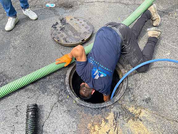 chicago plumbing experts performing a drain cleaning.
