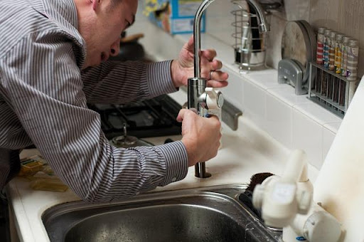 a plumber repairing a sink.