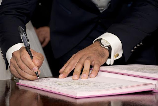 a man signing a permit.