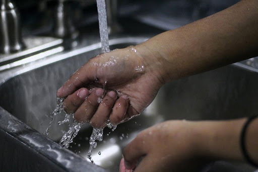 a man washing his hands.
