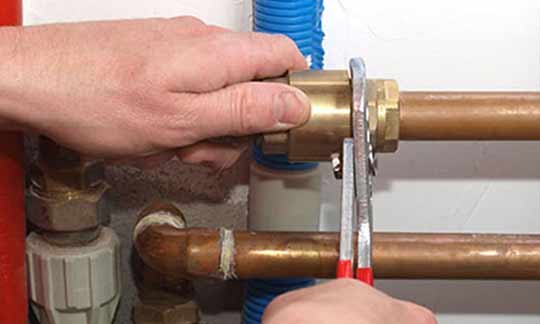 a plumber upgrading a customers plumbing.