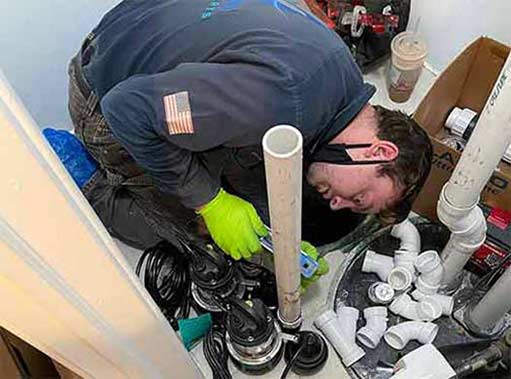 a plumber repairing a sump pump in wrigleyville.