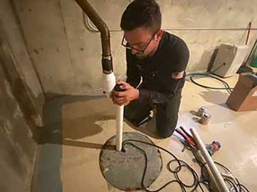 a plumber replacing an ejector pump in the city of chicago.
