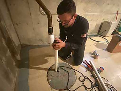 Replacing an Ejector Pump in Chicago a plumber replacing an ejector pump in the city of chicago.