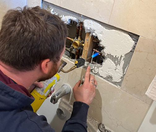 plumber replacing a shower valve in chicago