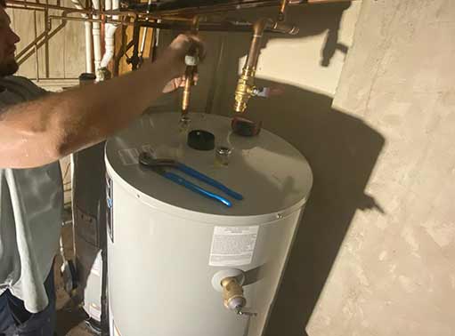 a man replacing a water heater in his home.