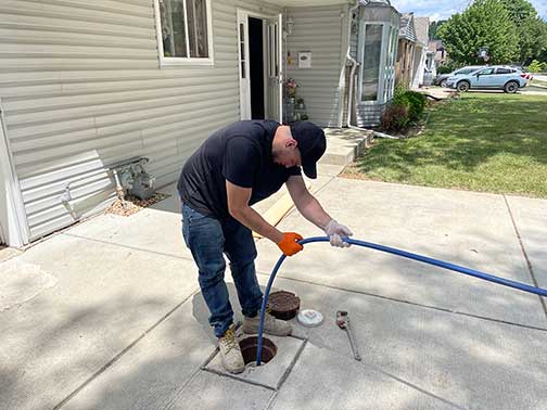 a plumber performing a sewer line cleaning in garfield ridge chicago