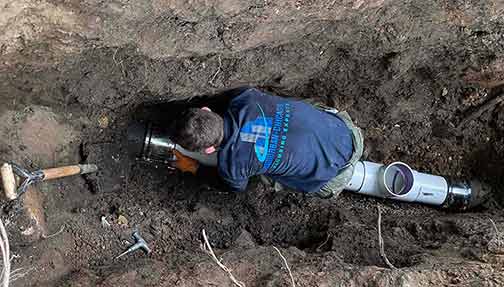 sewer line repair being performed by a professional plumber.