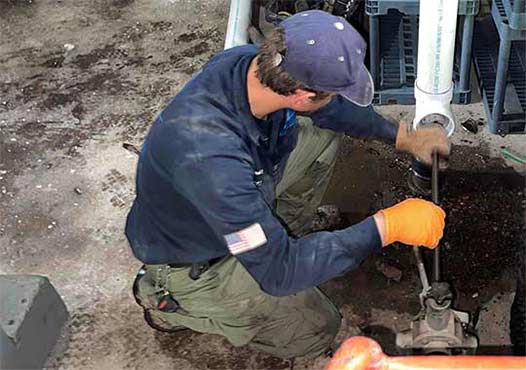 a professional plumber performing a sewer line rodding in chicago.