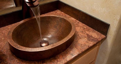 a sink bowl with water running.