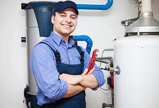 a plumber showing off his smooth water heater replacement in chicago.