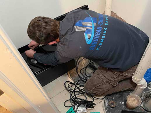 a plumber performing a sump pump installation.