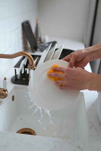 a person washing dishes.