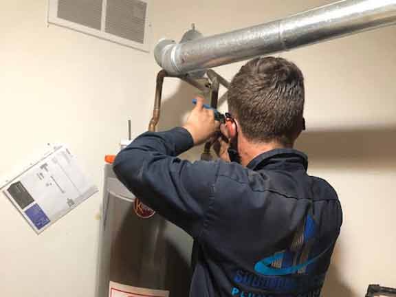 a chicago plumber replacing a customers water heater.